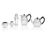 A matched four piece hammered silver bachelor's tea service the teapot by Charles Bradbury & Sons...