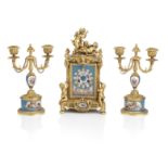 A late 19th century ormolu and Sevres style porcelain mounted mantel clock garniture the movement...