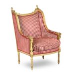 A George III style giltwood and gesso wingback armchair
