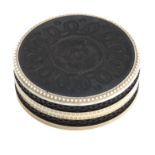 An early 19th century ebony and ivory patch box