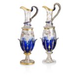 A large pair of French enamelled clear and coloured glass sectional ewers Late 19th Century