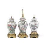 A matched garniture of three French gilt bronze mounted famille rose decorated porcelain vases th...