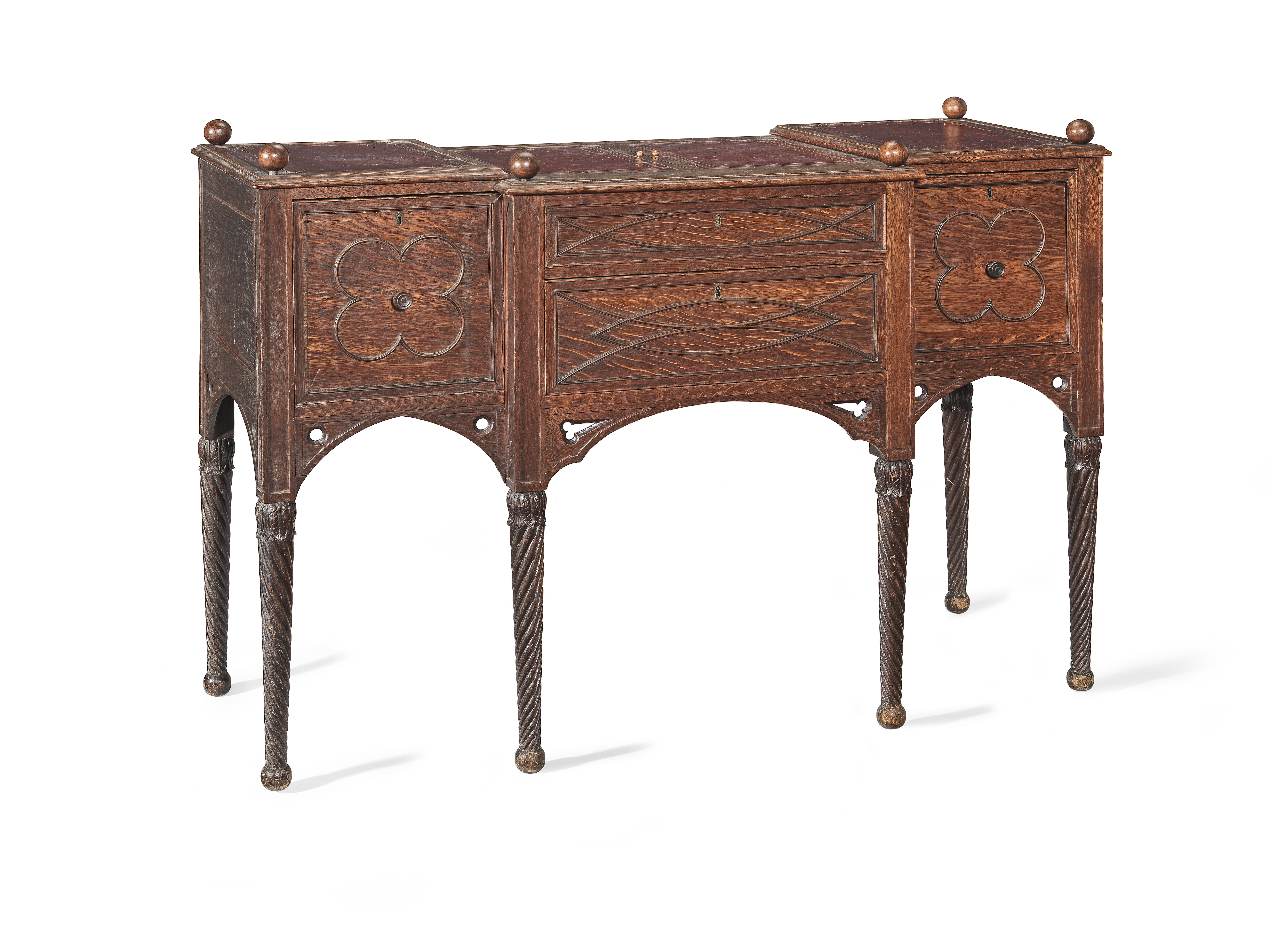 A Regency gothic revival oak breakfront dressing table after a design by George Smith