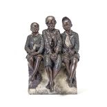An early 20th century Austrian painted terracotta novelty figural group of three seated boys