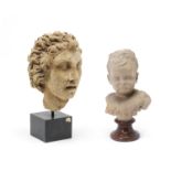 A French terracotta bust of a young child on porphyry soccle base together with a stone head frag...