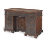 A George III and later mahogany architect's desk the blind fretwork and carving of a later date, ...