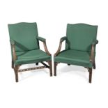 Two George III mahogany Gainsborough armchairs in the manner of Thomas Chippendale's 'Director' (2)