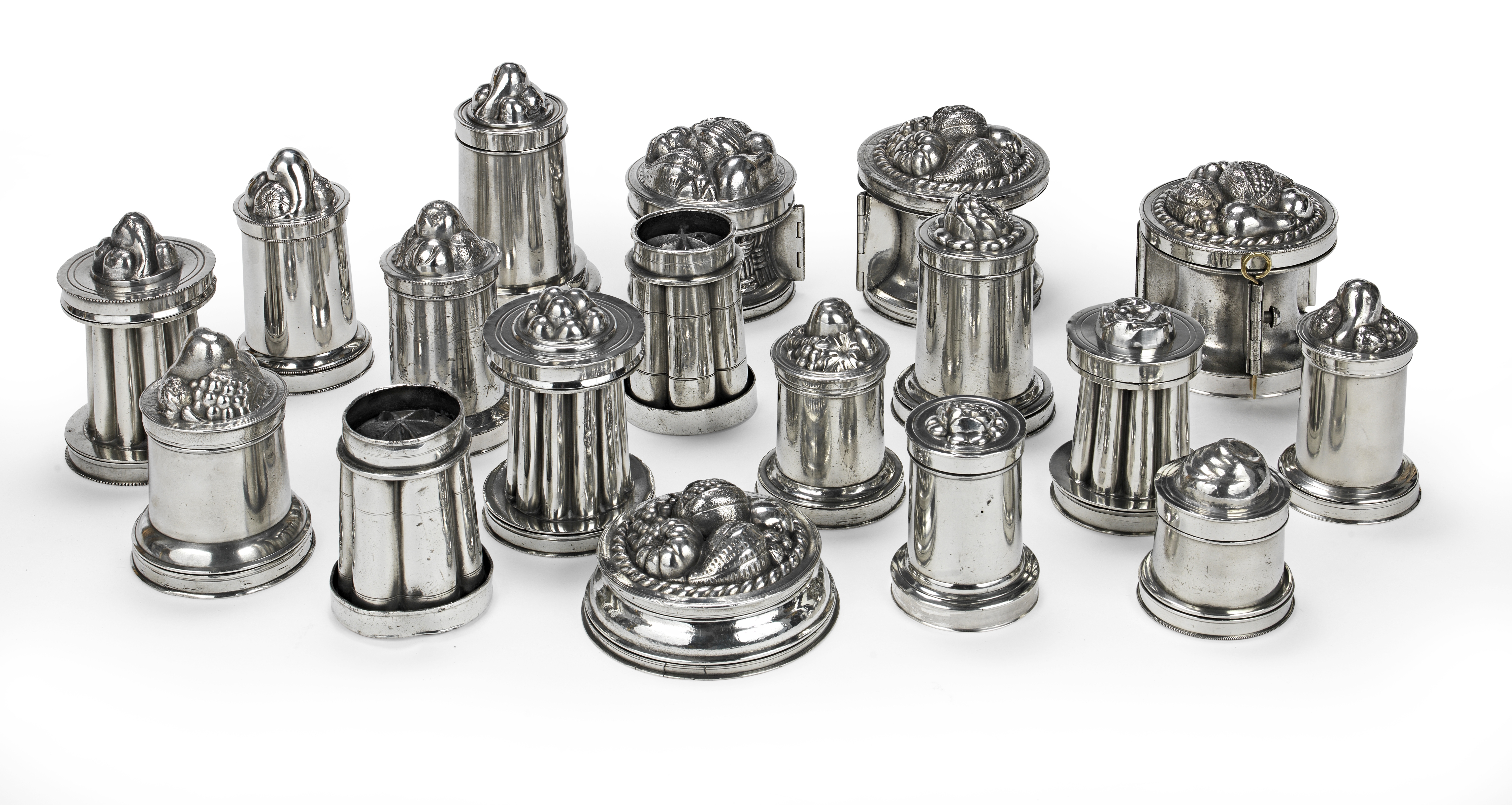 A collection of eighteen 19th Century polished pewter dessert or confectionary moulds two possibl...