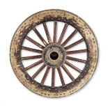 A Chinese carved and turned hardwood and iron bound ceremonial carriage wheel
