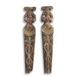 A rare pair of Elizabeth I/James I carved oak and polychrome-decorated figural pilasters, circa 1...