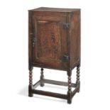 A small Charles II joined oak single-door enclosed-cupboard, circa 1670