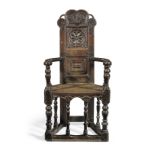 A rare James I joined oak caqueteuse open armchair, Scottish, dated 1606