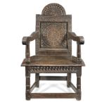 A James I joined oak panel-back 'caqueteuse' open armchair, Salisbury, circa 1625