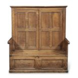 A small George III joined oak combination cupboard and settle, circa 1760 Popularly referred to a...