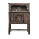 A Charles I joined and boarded oak 'mural' livery cupboard, West Country, circa 1640 On later sup...