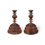 A pair of turned lignum vitae candlesticks (2)