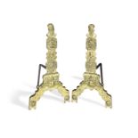 An interesting pair of brass alloy and wrought iron firedogs Possibly 16th century and cast with ...