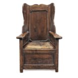 A George III joined pine and ash 'lambing' wing armchair, circa 1800