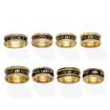 A collection of enamel mourning rings, (8)
