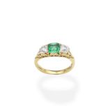 An emerald and diamond three-stone ring