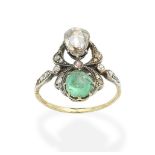 An emerald and diamond ring