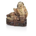 A large soapstone figure of Daoist Immortal on wood stand Qing Dynasty, 19th century