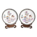 A pair of Canton enamel saucer dishes with wood display stands Qing Dynasty, 19th century