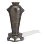 A bronze vase on integral stand 17th/18th century