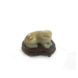 A carved jade lion-dog and wood stand (2)