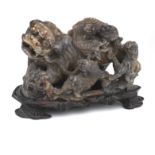 A soapstone model of a Buddhist lion dog and cubs on stand 19th century