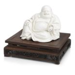 A well-modelled blanc-de-chine figure of Budai on wood stand Early Qing Dynasty