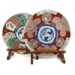 A matched pair of Imari chargers on wooden stands Late 19th century (4)