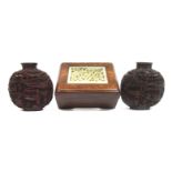 Two cinnabar lacquer-style snuff bottles and a small hardwood box inset with jade