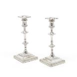 A pair of George III silver candlesticks William Cafe, London 1767, the drip-pans with the mark o...