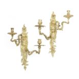 A pair of French gilt bronze twin light wall appliques in the Louis XV style, probably 19th centu...