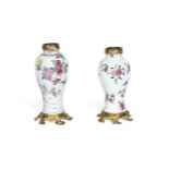 A pair of Louis XV gilt bronze mounted matched Chinese famille rose porcelain garniture vases th...