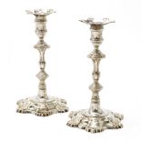 A pair of George II silver candlesticks by John Swift, London 1753, one matched nozzle, one nozzl...