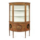 An Edwardian satinwood and polychrome decorated demi-lune display cabinet