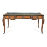 A French late 19th century gilt bronze mounted rosewood and bois satine bureau plat in the Louis ...