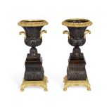 A pair of Louis Philippe gilt and patinated bronze garniture urns (2)