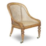 A 19th century oak framed bergère open armchair