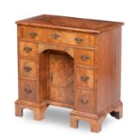 A George II style Mahogany featherbanded kneehole desk, mid 20th century