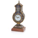 A late 19th/early 20th century champlevé enamel time piece