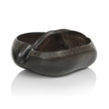 A carved and polished Coco de Mer nutshell (Lodoicea Maldivica) formed as a basket