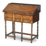 A William and Mary and later walnut cross banded and inlaid bureau on stand