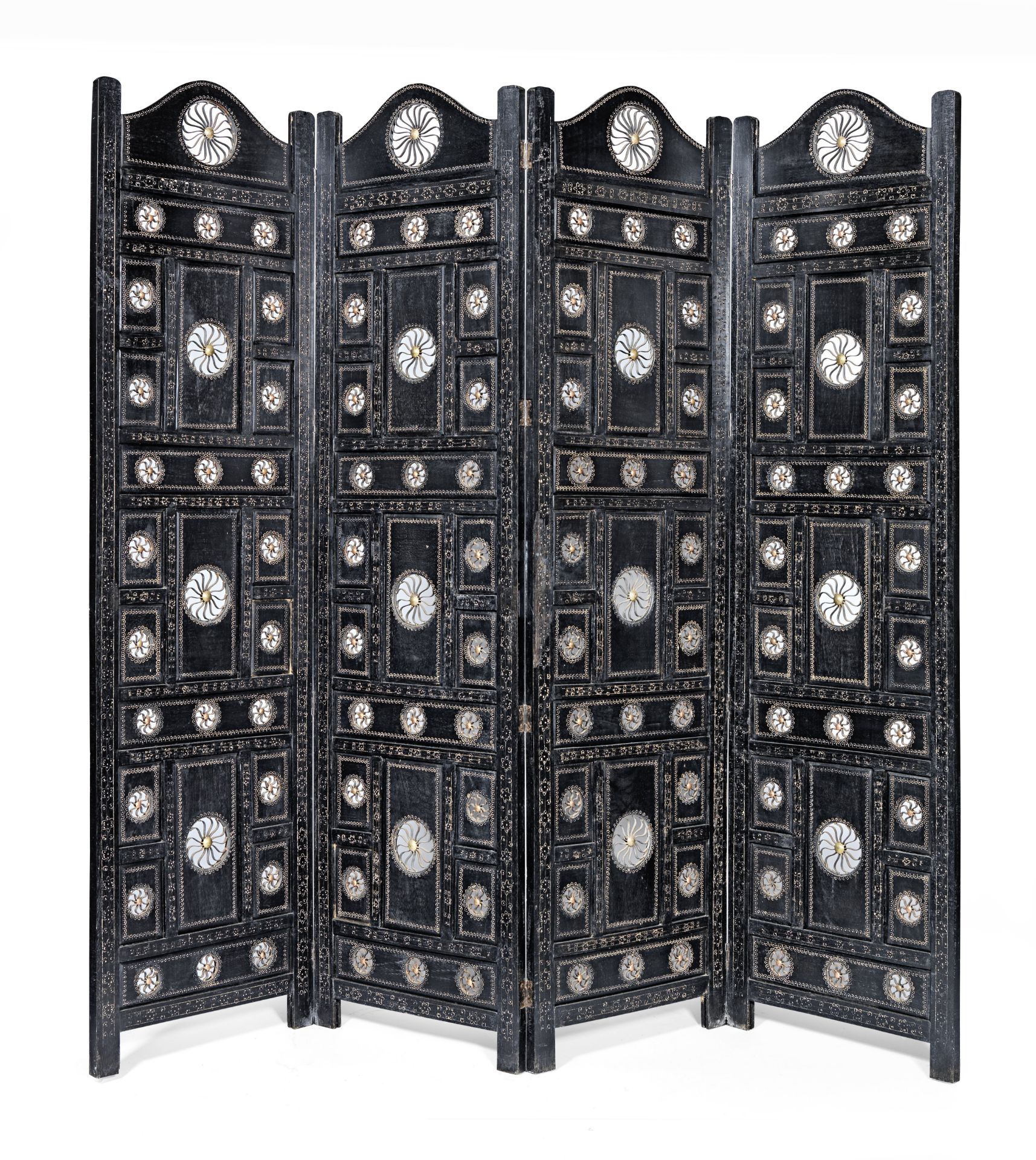 An Indian ebonised hardwood and metal mounted four panel screen