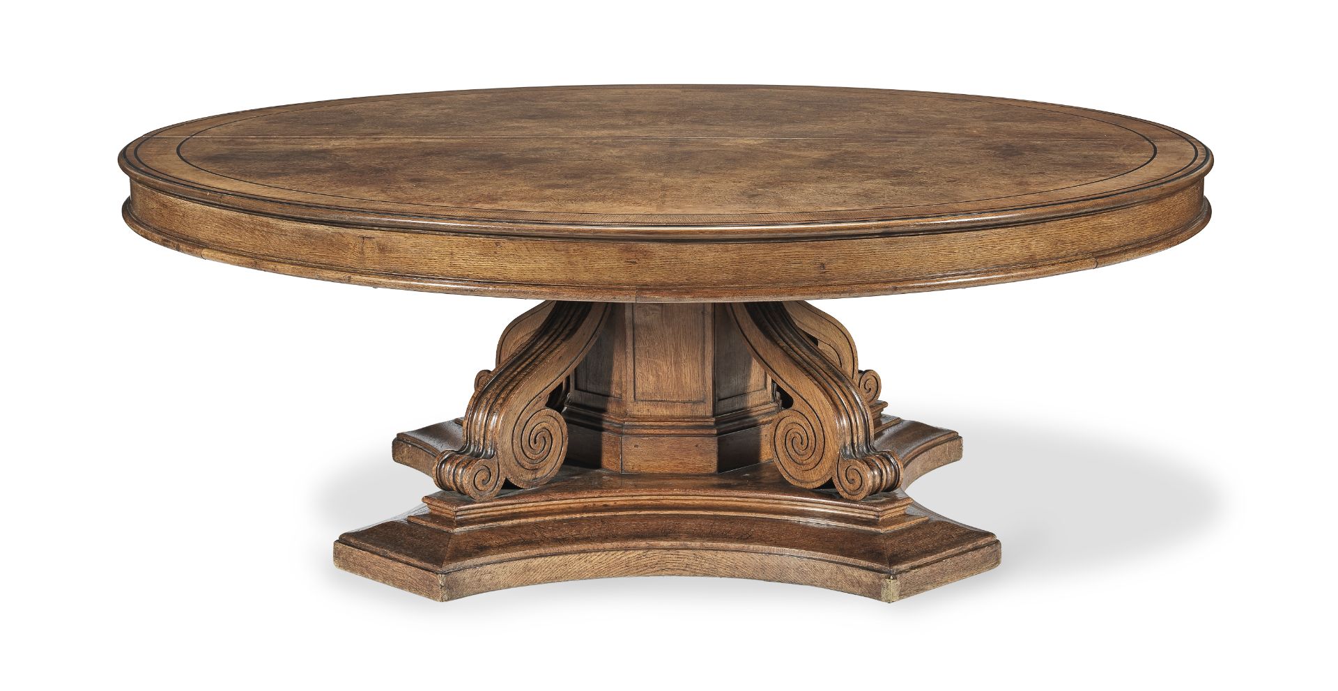 A large mid-19th century oak, pollard oak and ebony line inlaid circular extending dining table