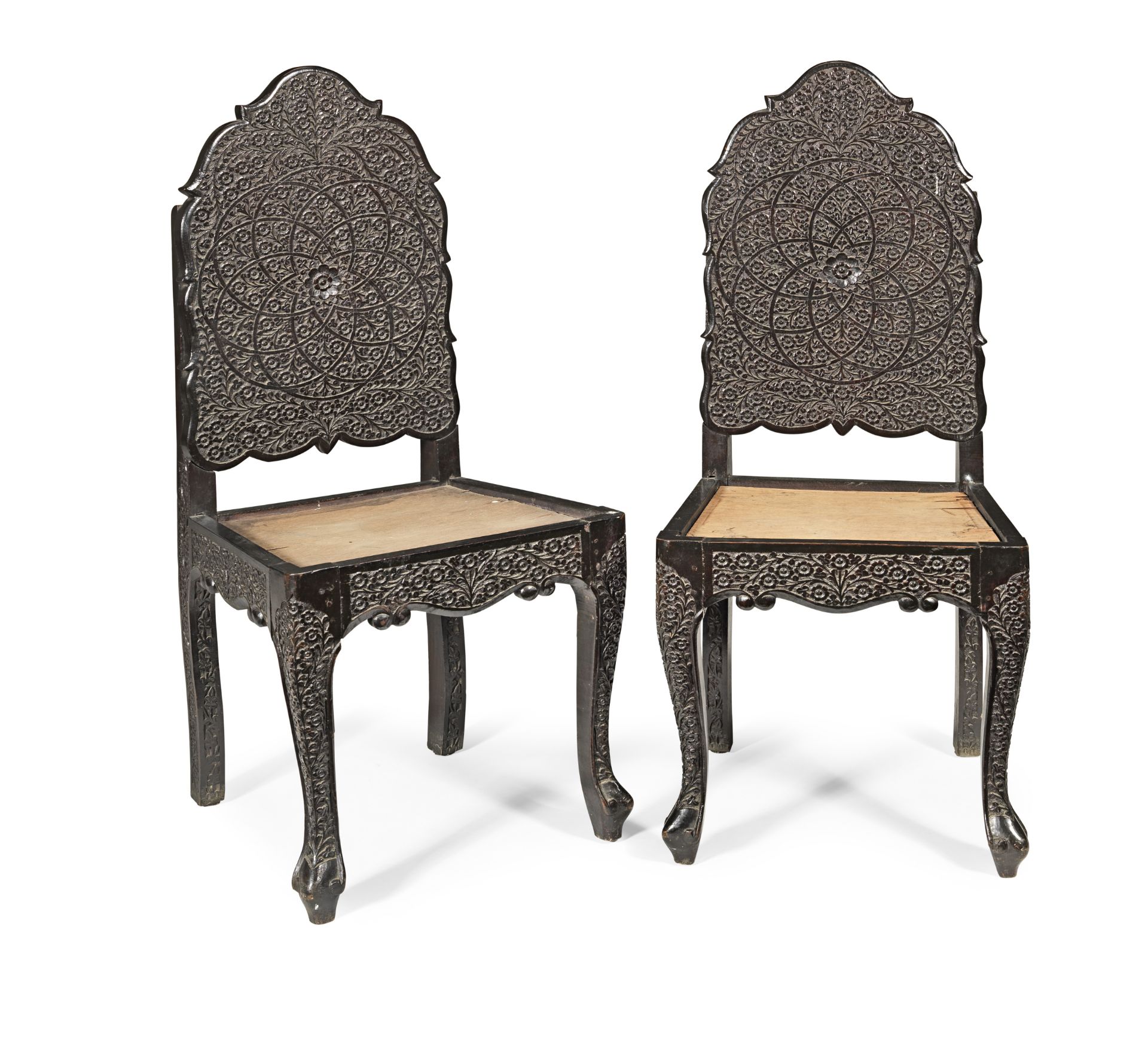 A pair of Anglo-Indian 19th century carved ebonised chairs (2)