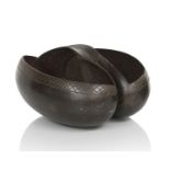 A carved and polished Coco de Mer nutshell (Lodoicea Maldivica) formed as a basket