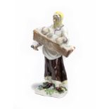 A Meissen figure of a mother holding a child in a crib Circa 1760